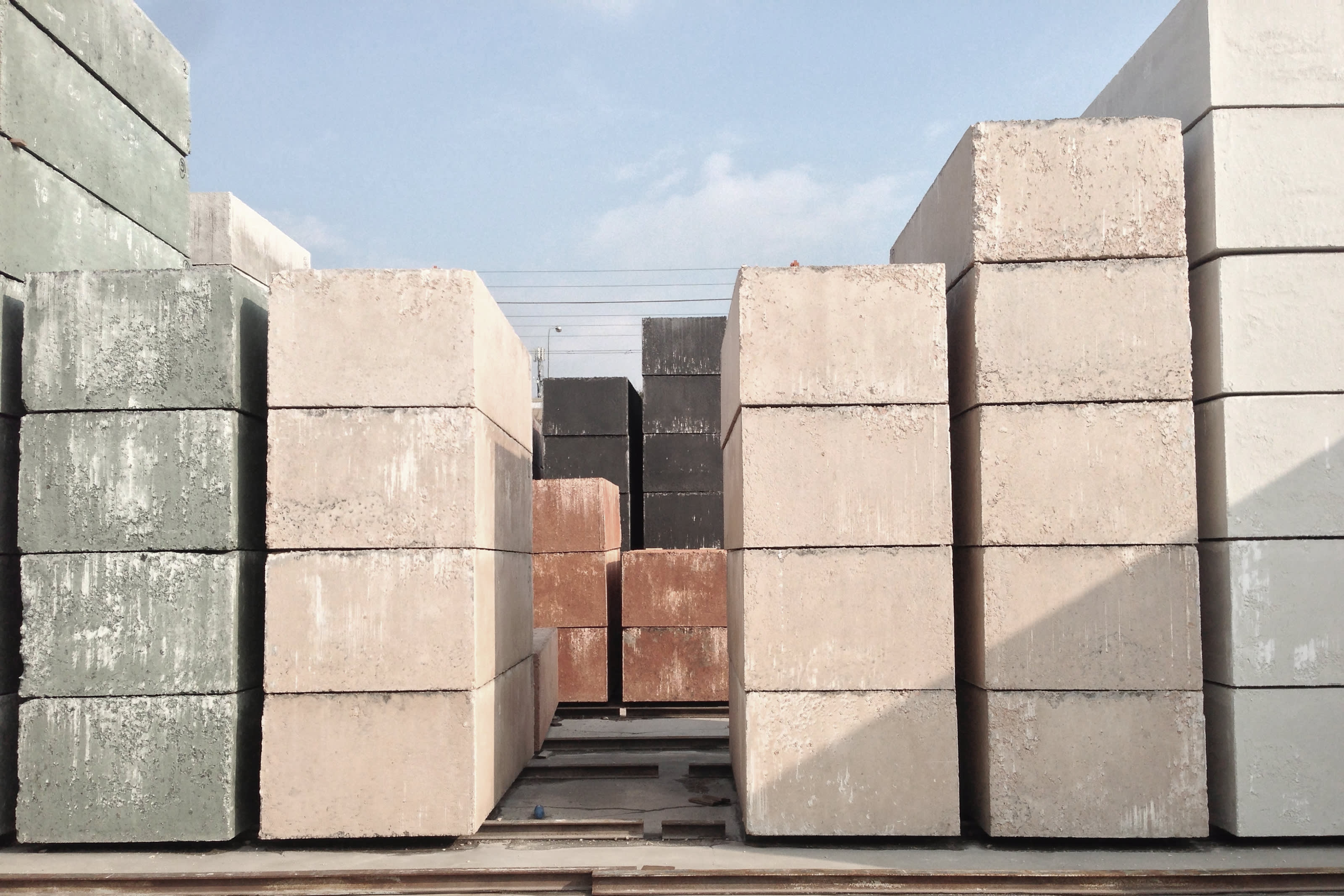 Cast blocks cure in the yard for two weeks before cutting them into slabs.